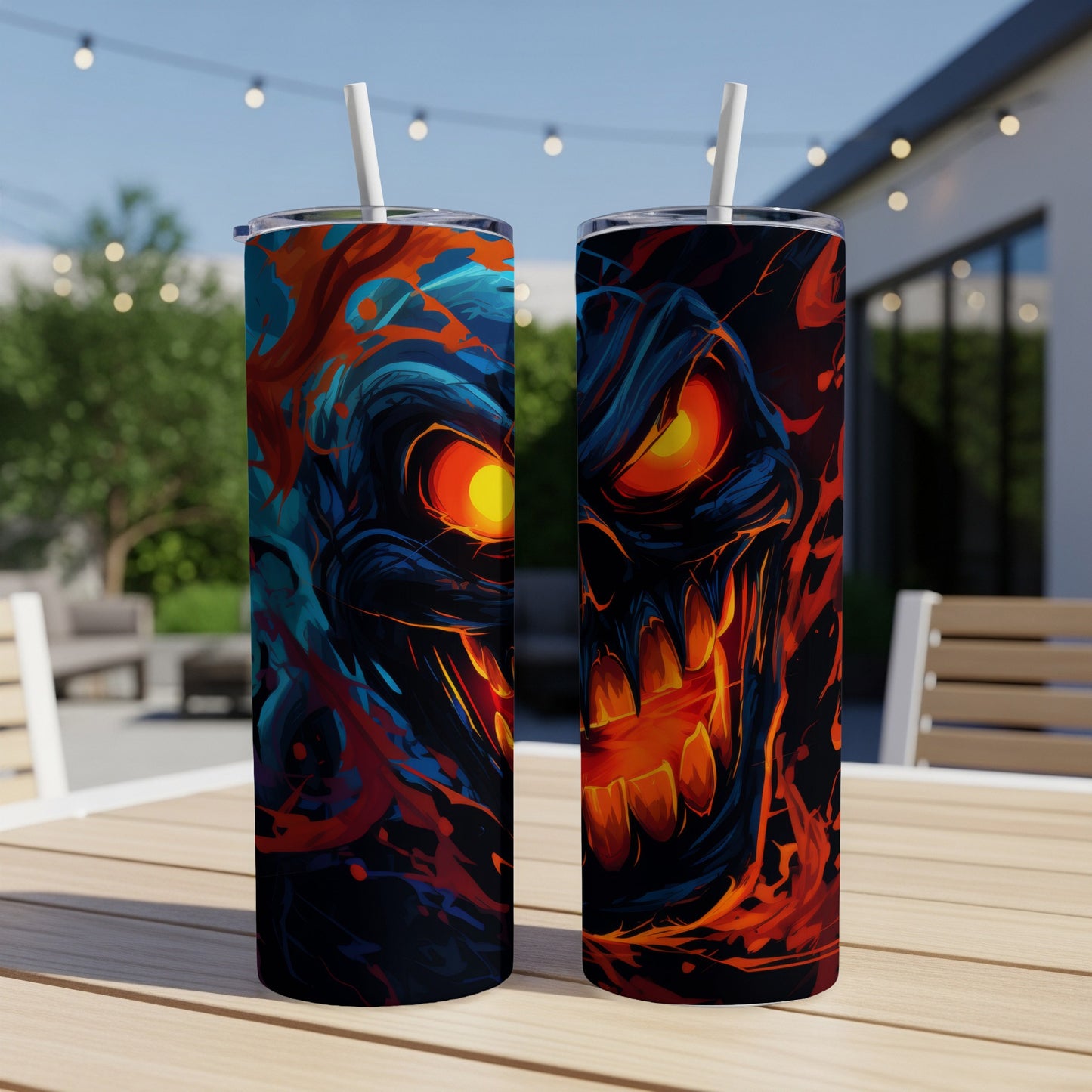 Two tumblers featuring a fiery, glowing skull design with blue and orange abstract elements.