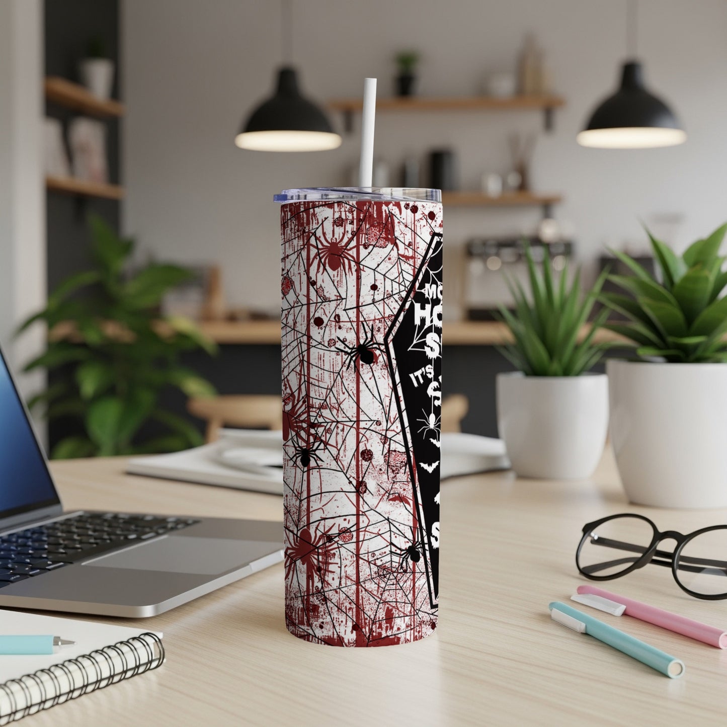 Halloween spiderweb tumbler with bloody handprints and straw.