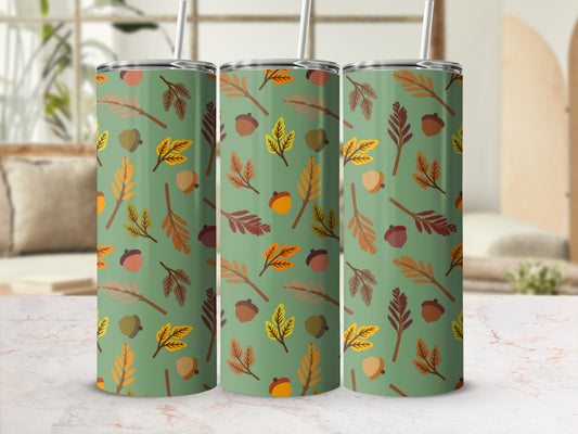 Green tumbler with repeating pattern of acorns and autumn leaves.