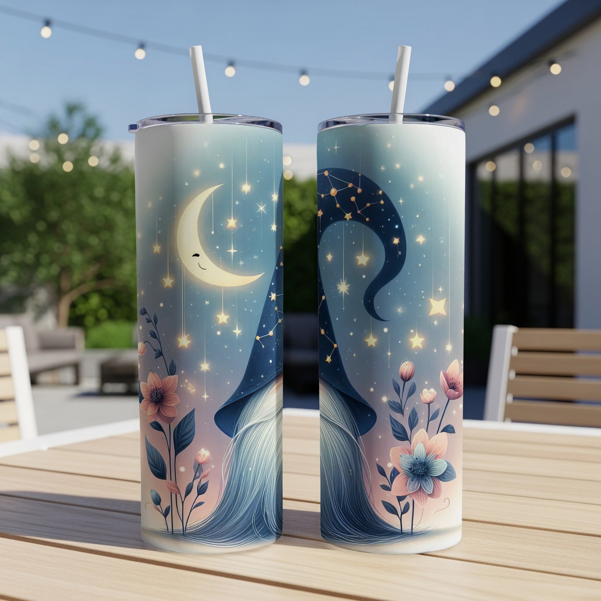 Two tumblers with a gnome, moon, and stars design sit on a table.