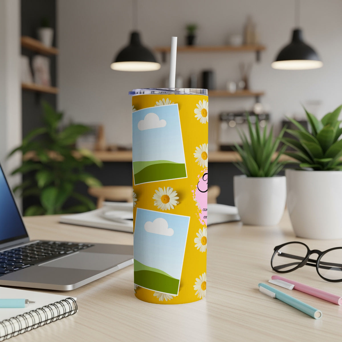 Yellow tumbler with daisy pattern, two photo frames, and pink text.