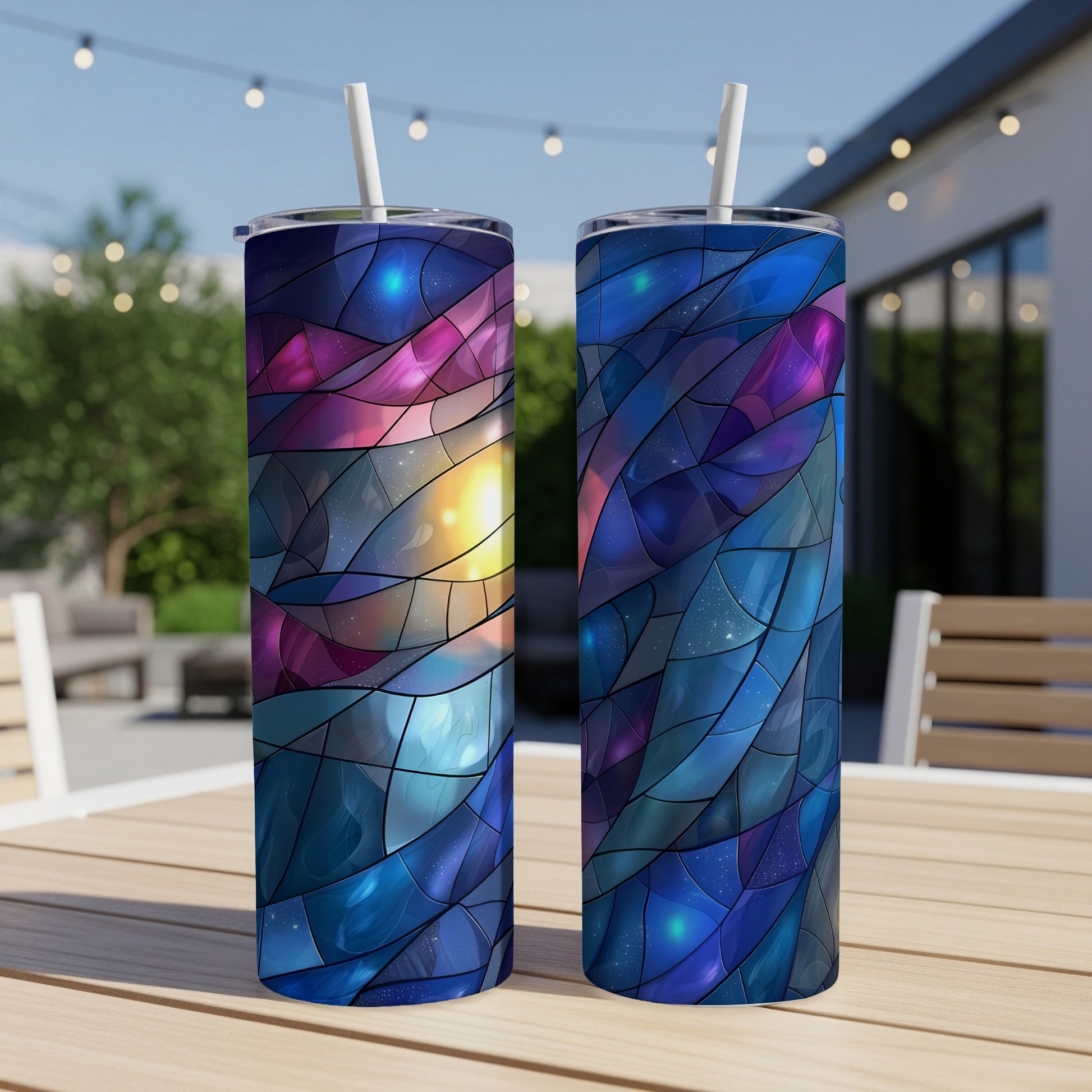 Two tumblers with a colorful stained-glass celestial design on a table.