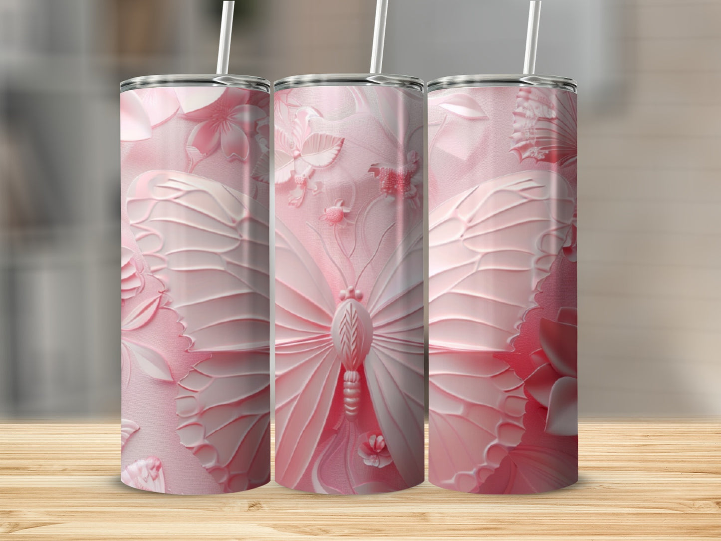 Three pink tumblers with embossed butterfly and floral designs.