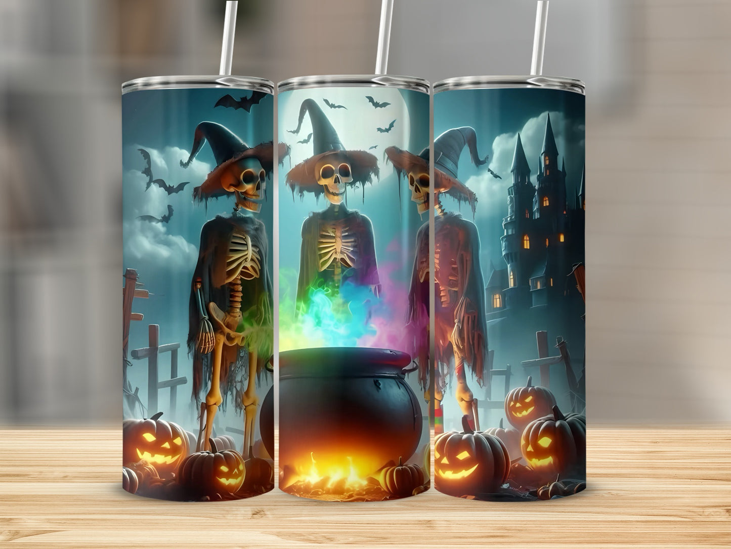 Three Halloween tumblers with skeletons, pumpkins, and a spooky castle.