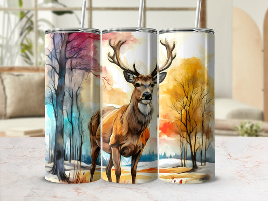 Tumbler with deer and colorful autumn trees against a blurry background.