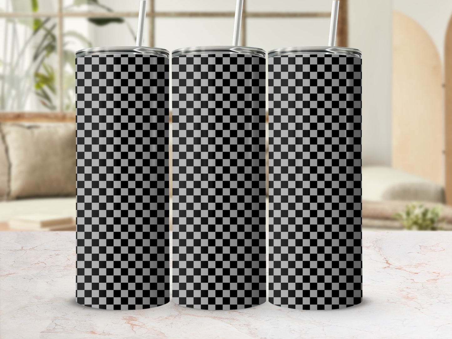 Three tumblers with black and white checkered pattern on a marble surface.