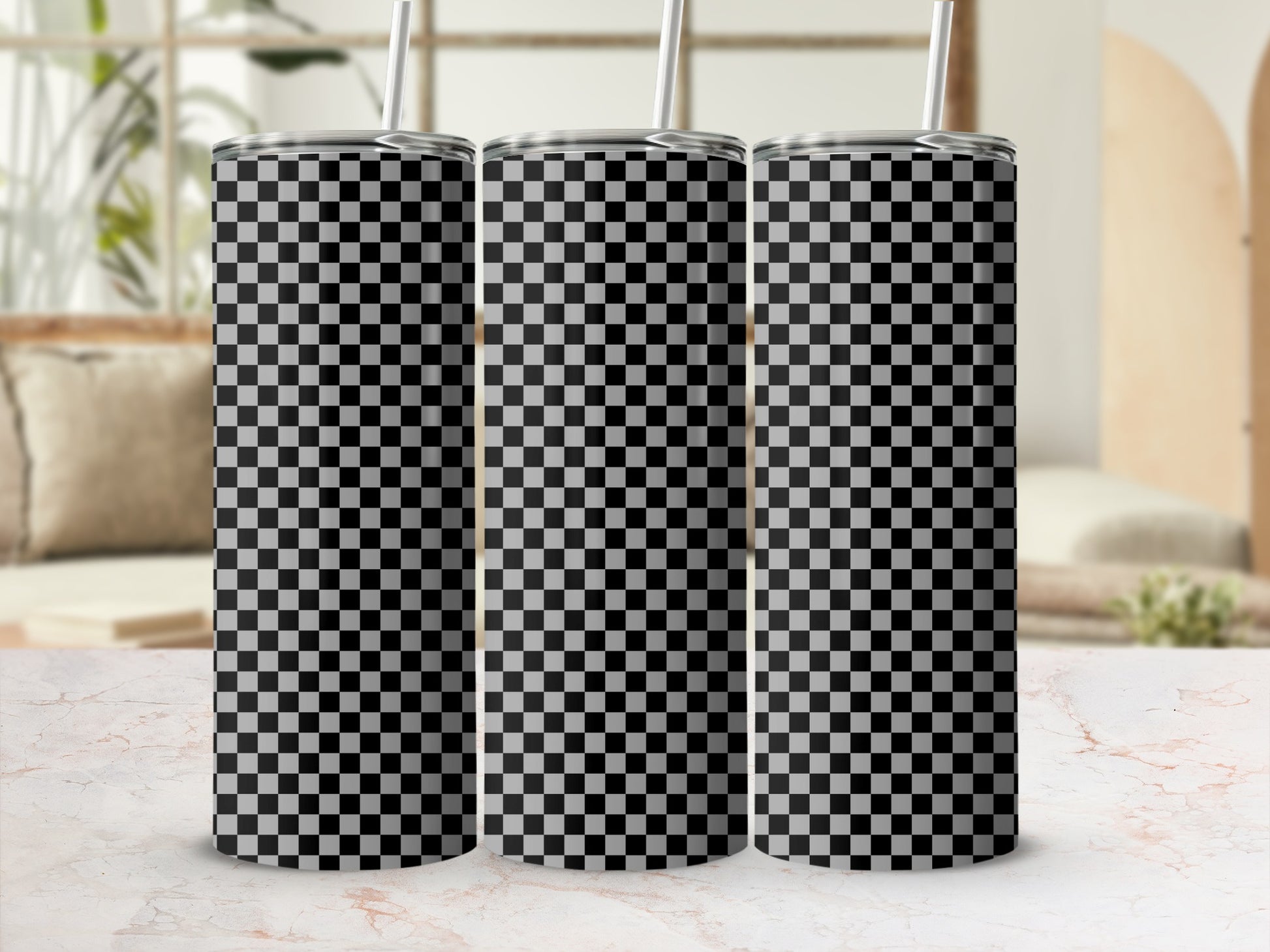 Three tumblers with black and white checkered pattern on a marble surface.