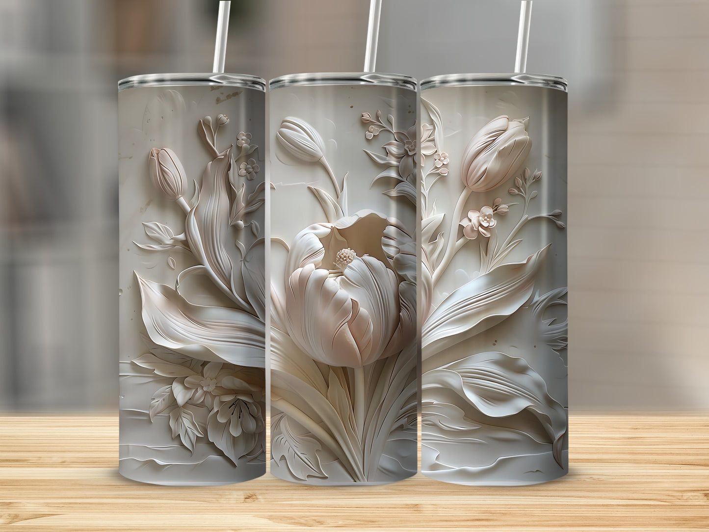 Three white textured tumblers with embossed floral tulip designs and straws.
