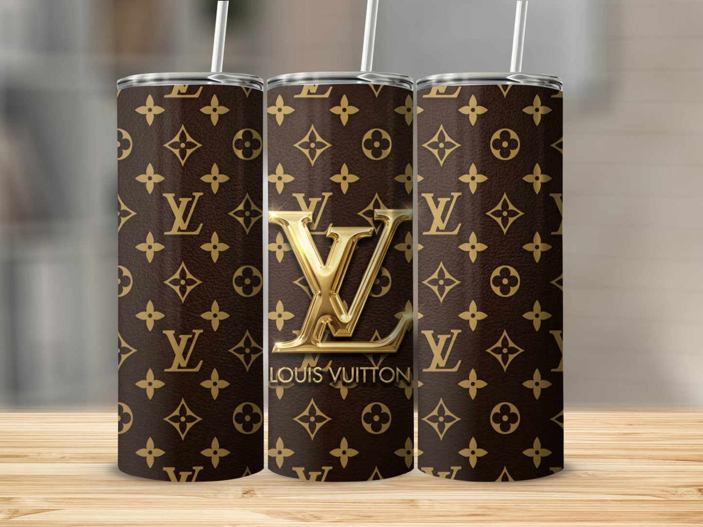 Three tumblers with Louis Vuitton monogram pattern, one with raised gold logo and text.