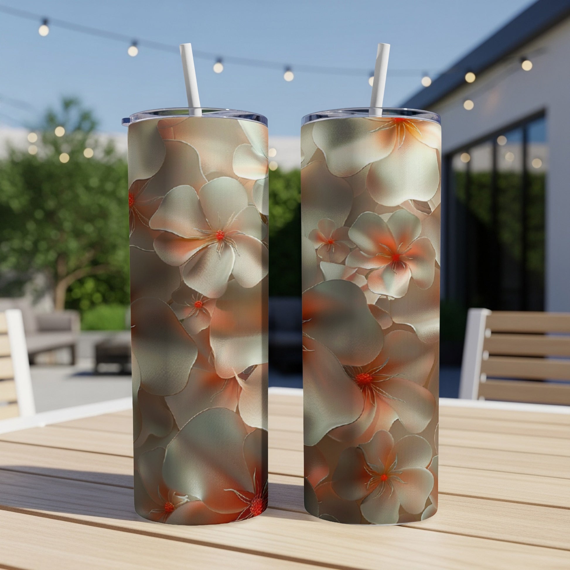 Two tall tumblers with a floral pattern featuring light pink and white flowers.