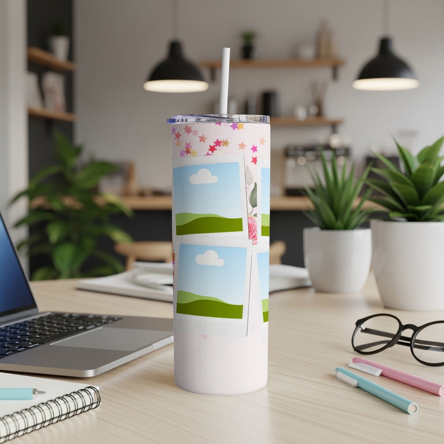 Pink tumbler with star pattern and photo frames of landscapes.