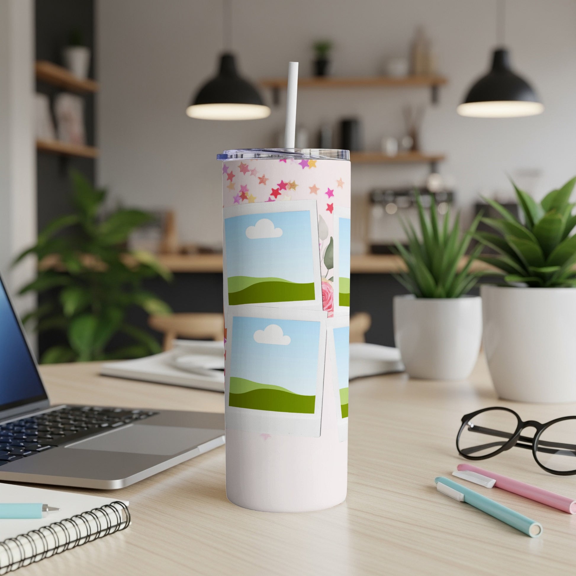 Pink tumbler with star pattern and photo frames of landscapes.