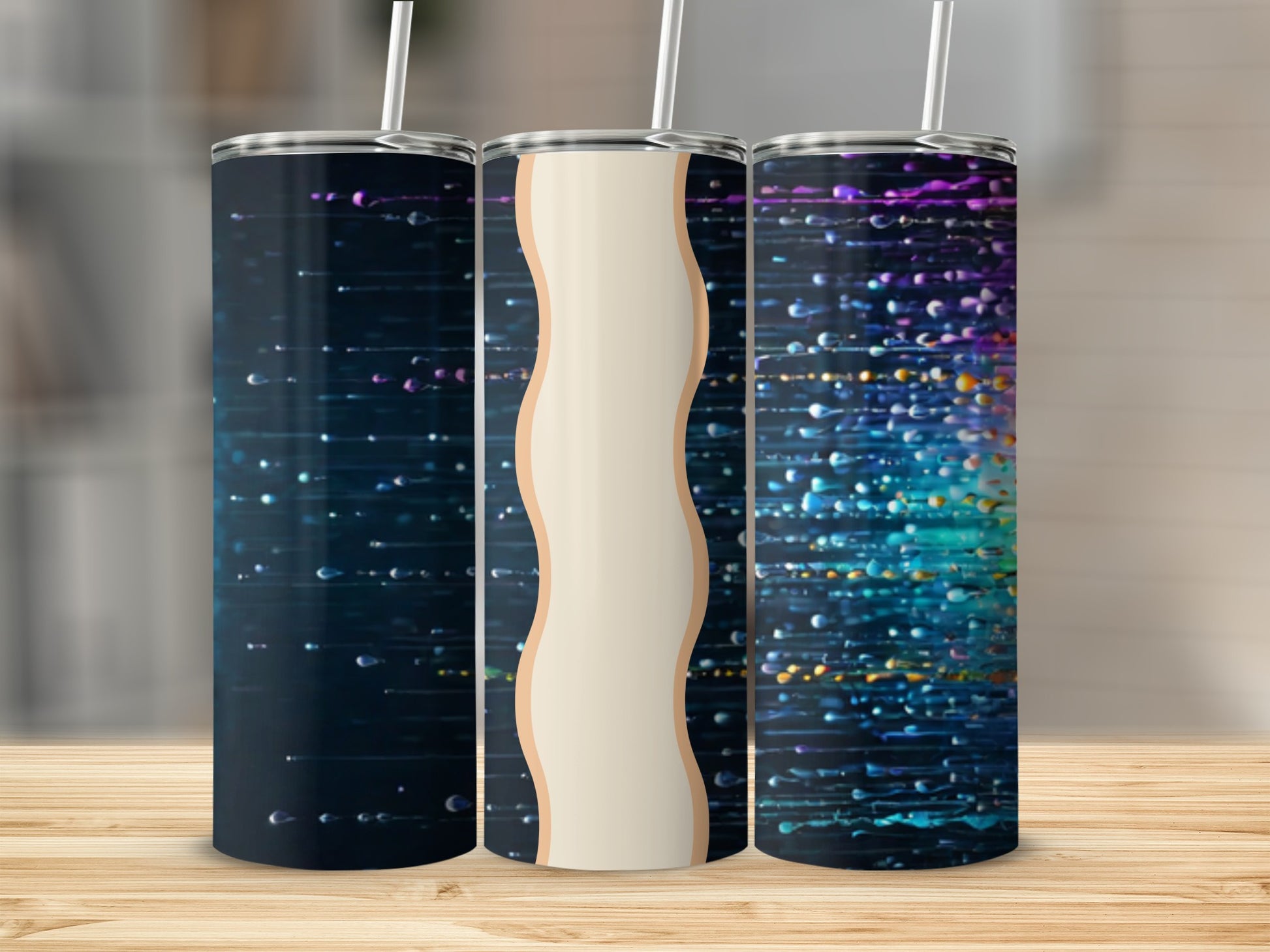 Three tumblers with abstract colorful splattered paint designs.