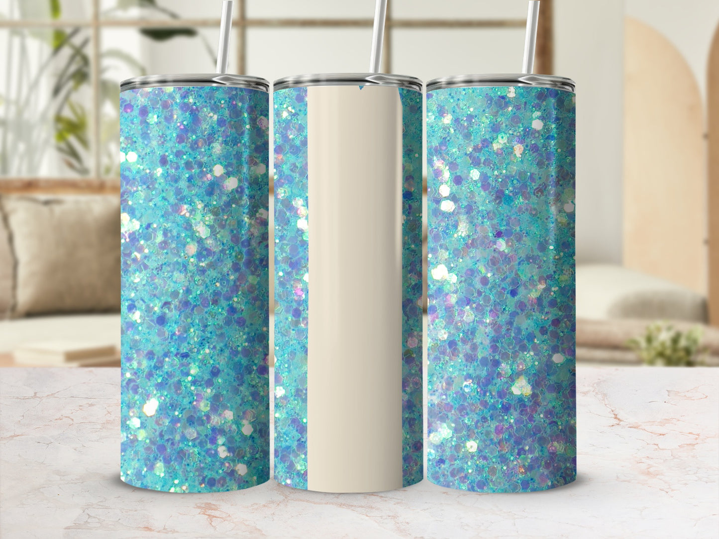 Three glitter tumblers with straws on a marble surface.
