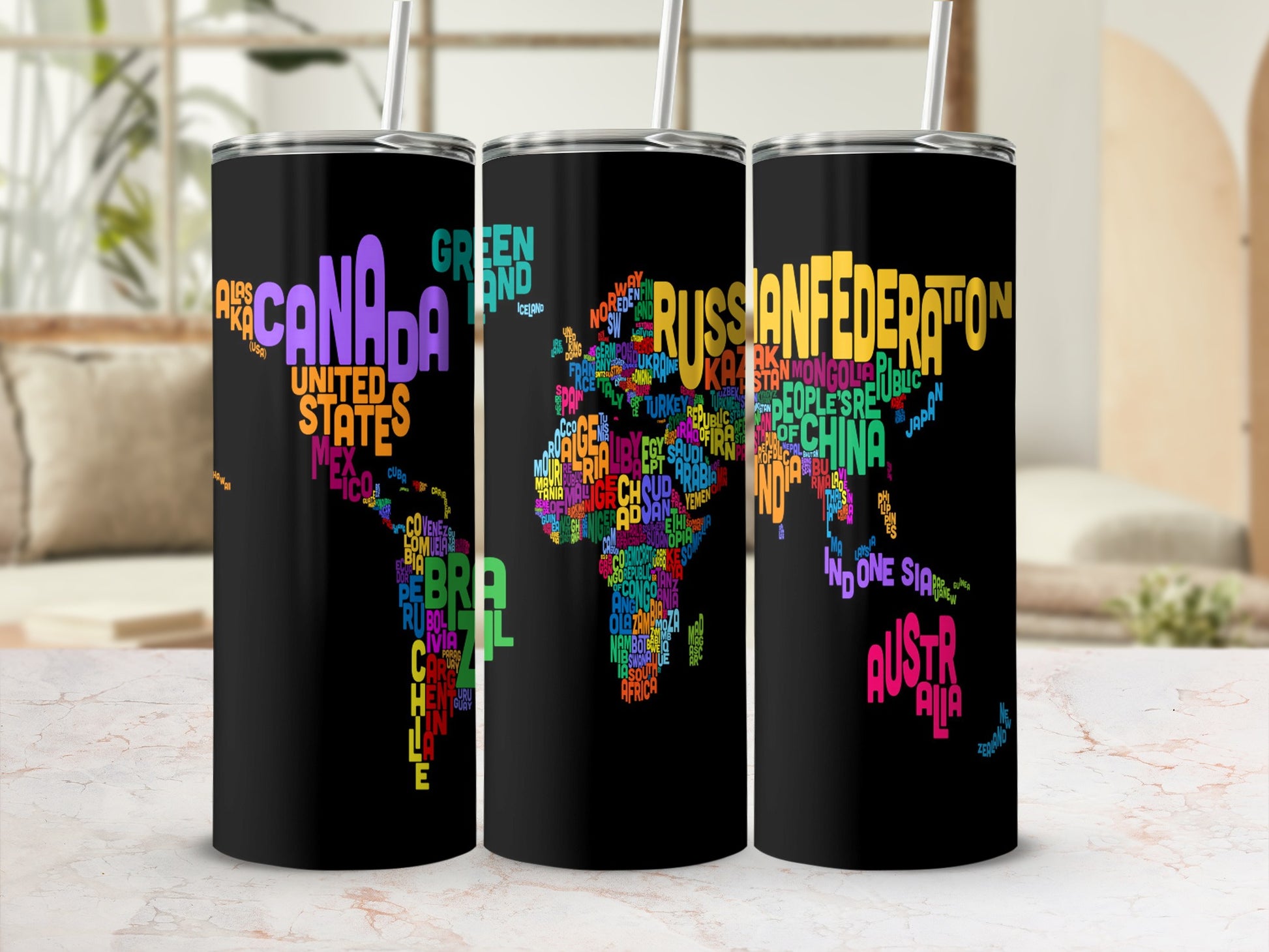 Black tumblers with multicolor world map made of country names.