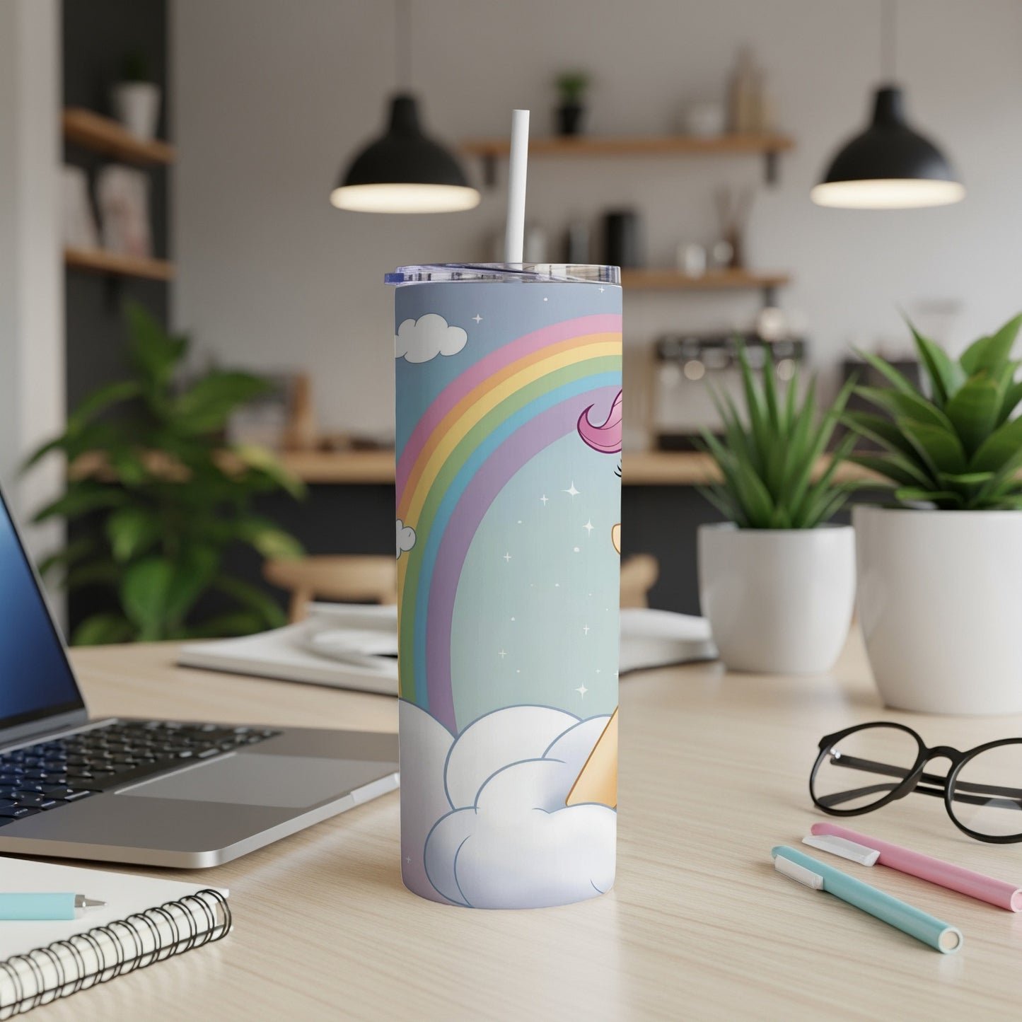 Unicorn and rainbow on a cloud-patterned tumbler with a straw.