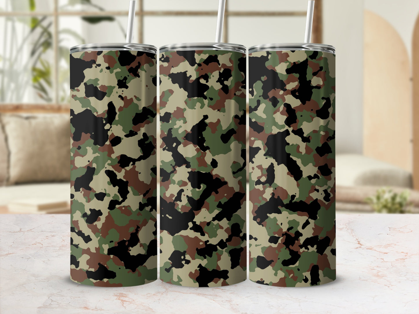 Three stainless steel tumblers with camouflage pattern and straws.