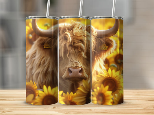 Close-up of a fluffy Highland cow with sunflowers, on a tumbler.