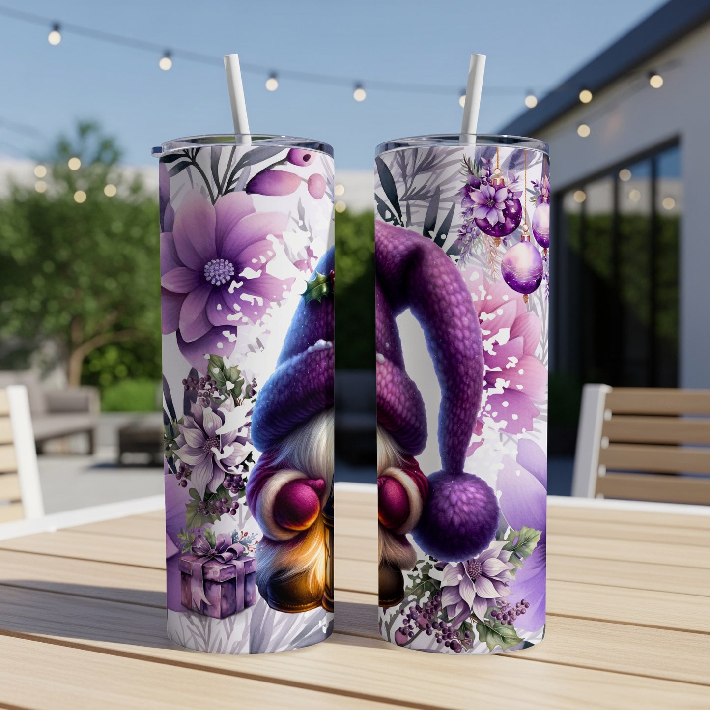 Two tumblers with gnome and purple floral designs sit on a table.
