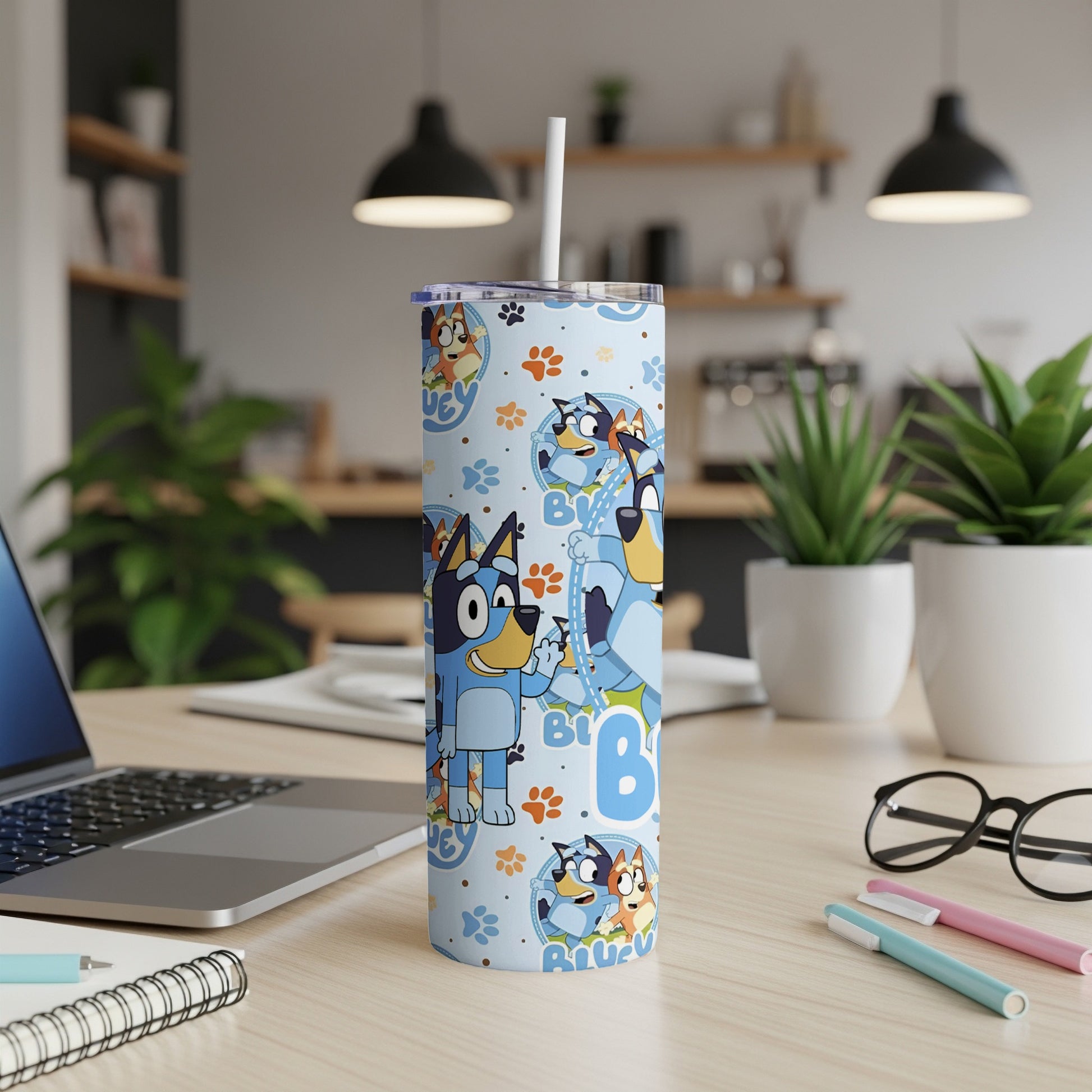 Bluey characters on a blue patterned tumbler with straw.