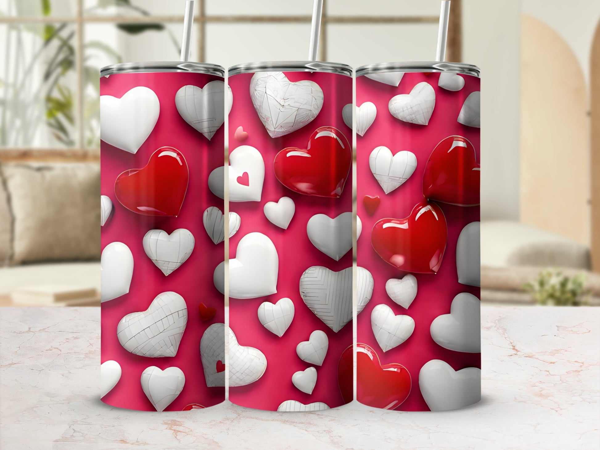 Three red and white heart-patterned tumblers with straws on a pink background.