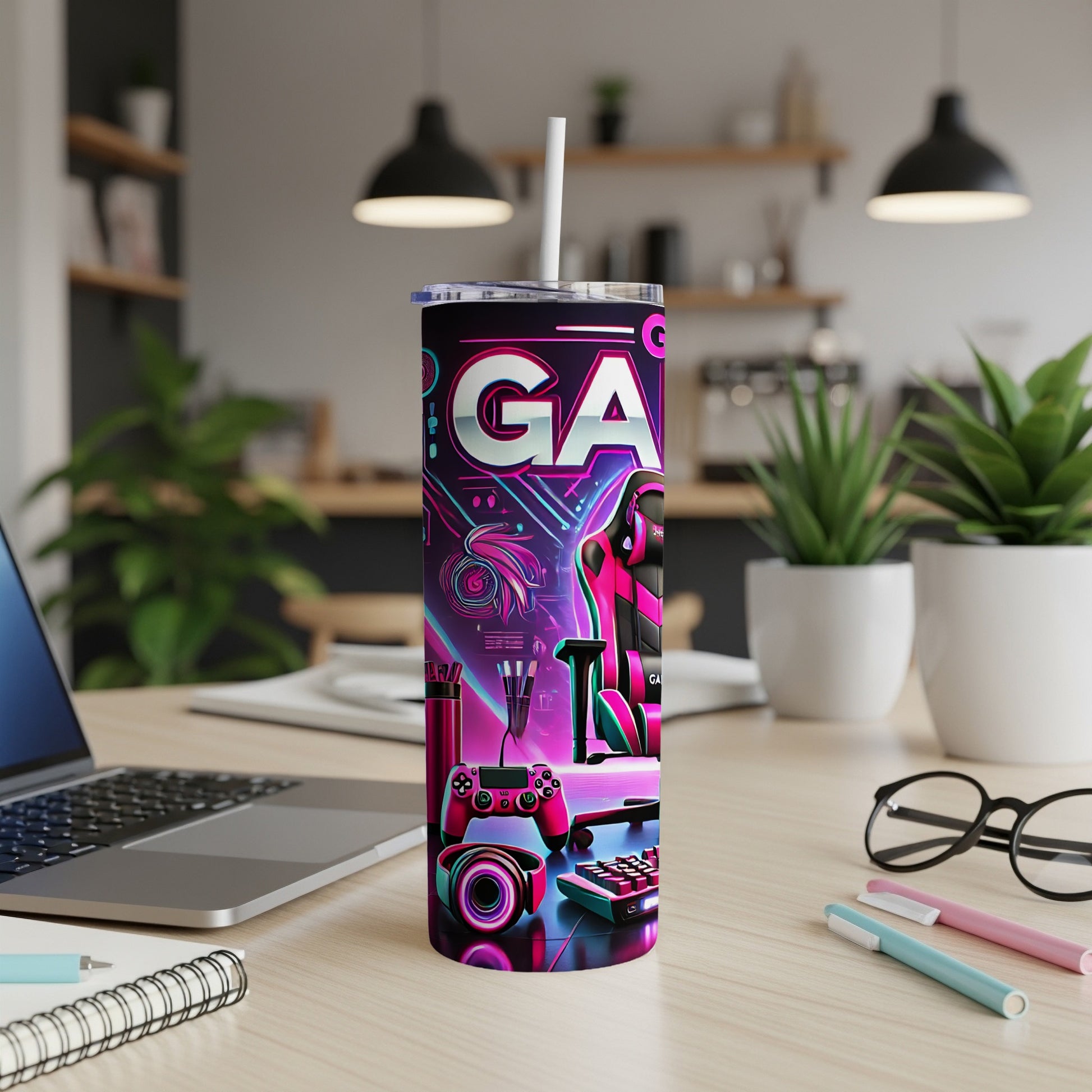 Pink and blue neon gaming graphics on a tumbler with gaming accessories.