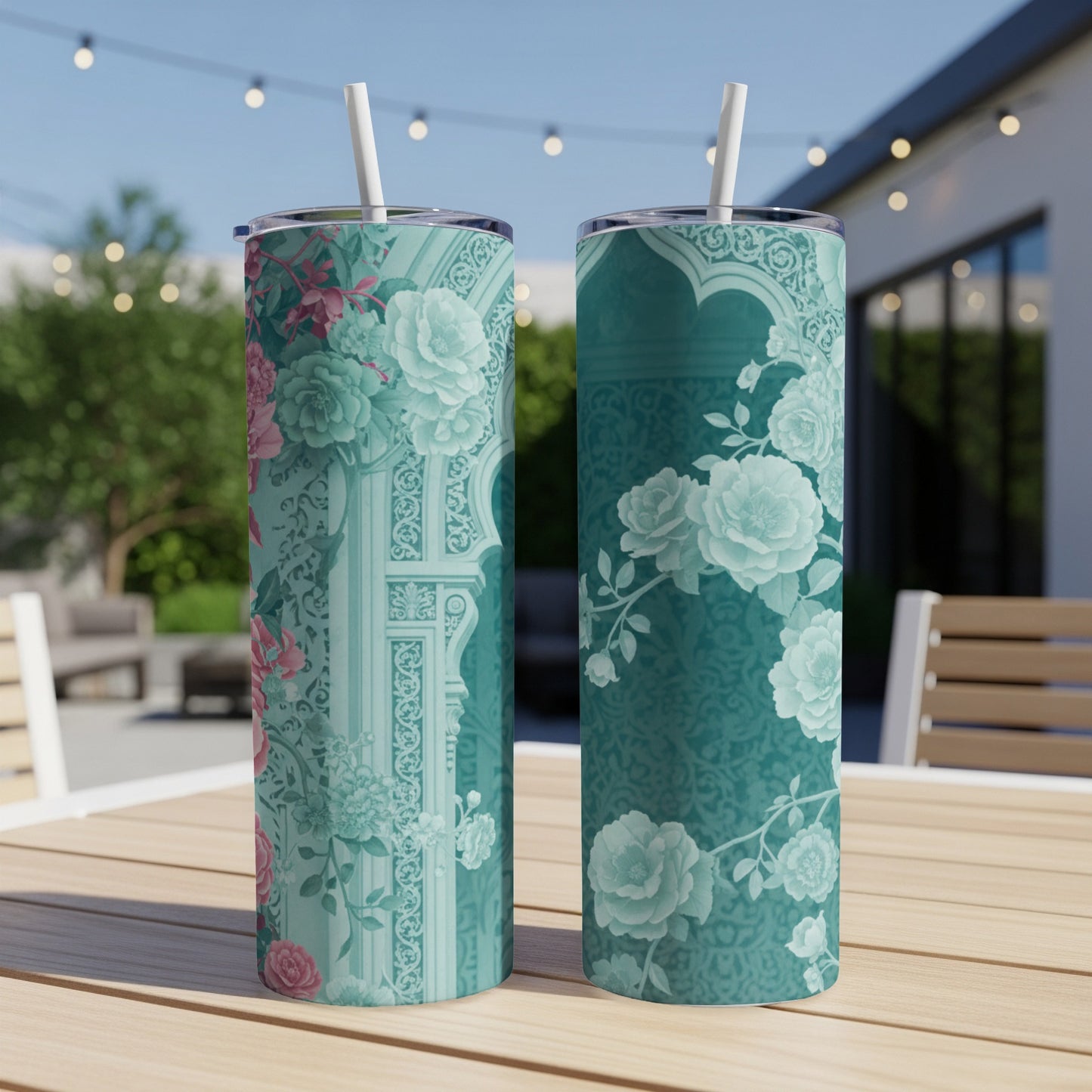 Two teal tumblers with floral pattern and architectural elements.