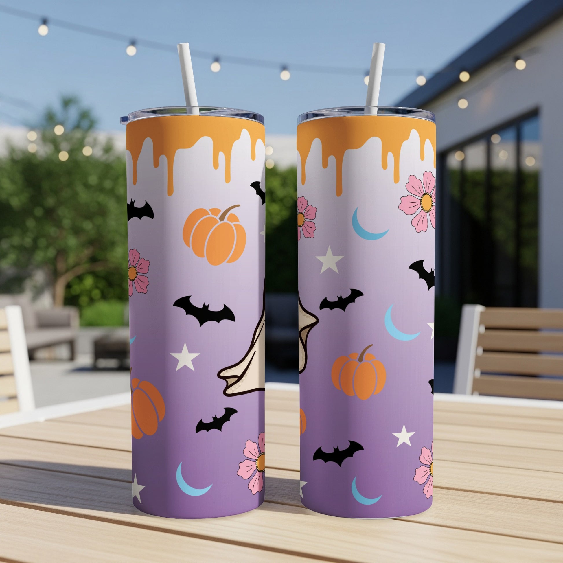 Two tumblers with Halloween pattern of pumpkins, bats, moons, and flowers.