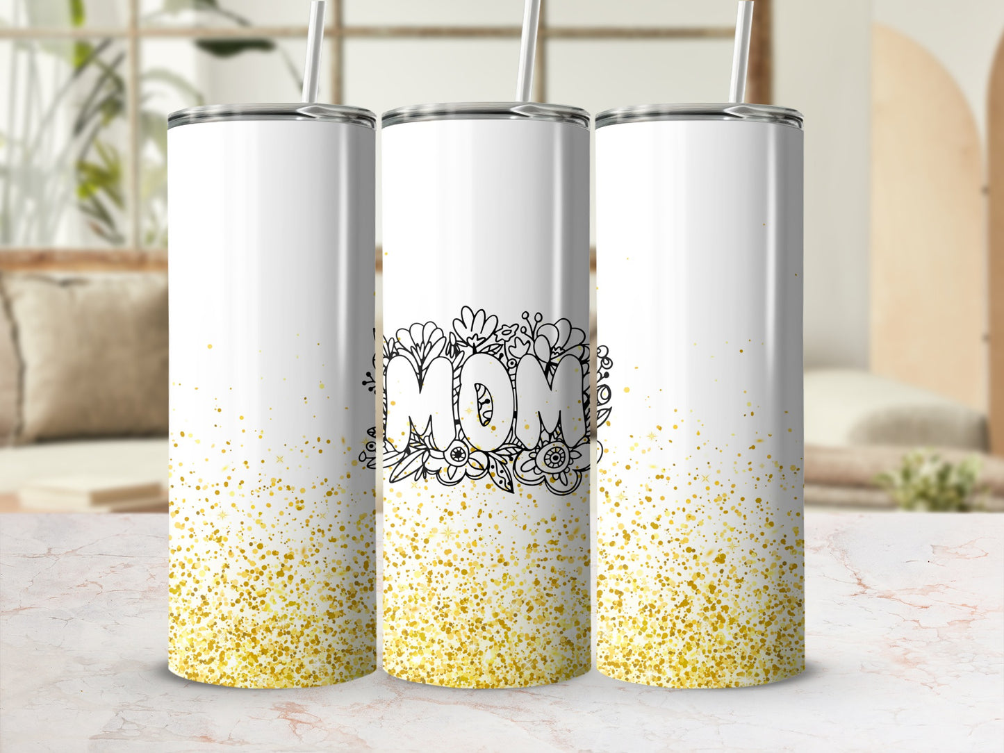 Three white tumblers with gold glitter splatter and "MOM" floral design.