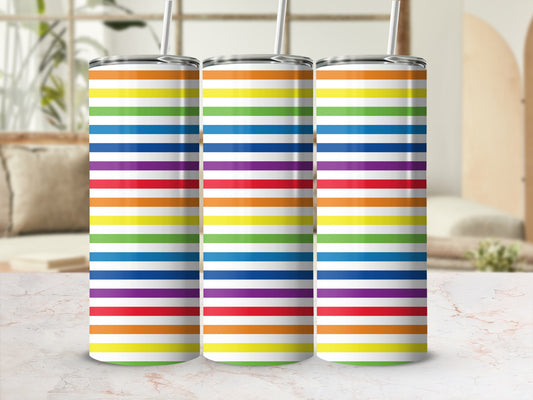 Three rainbow striped tumblers with straws on a marble surface.