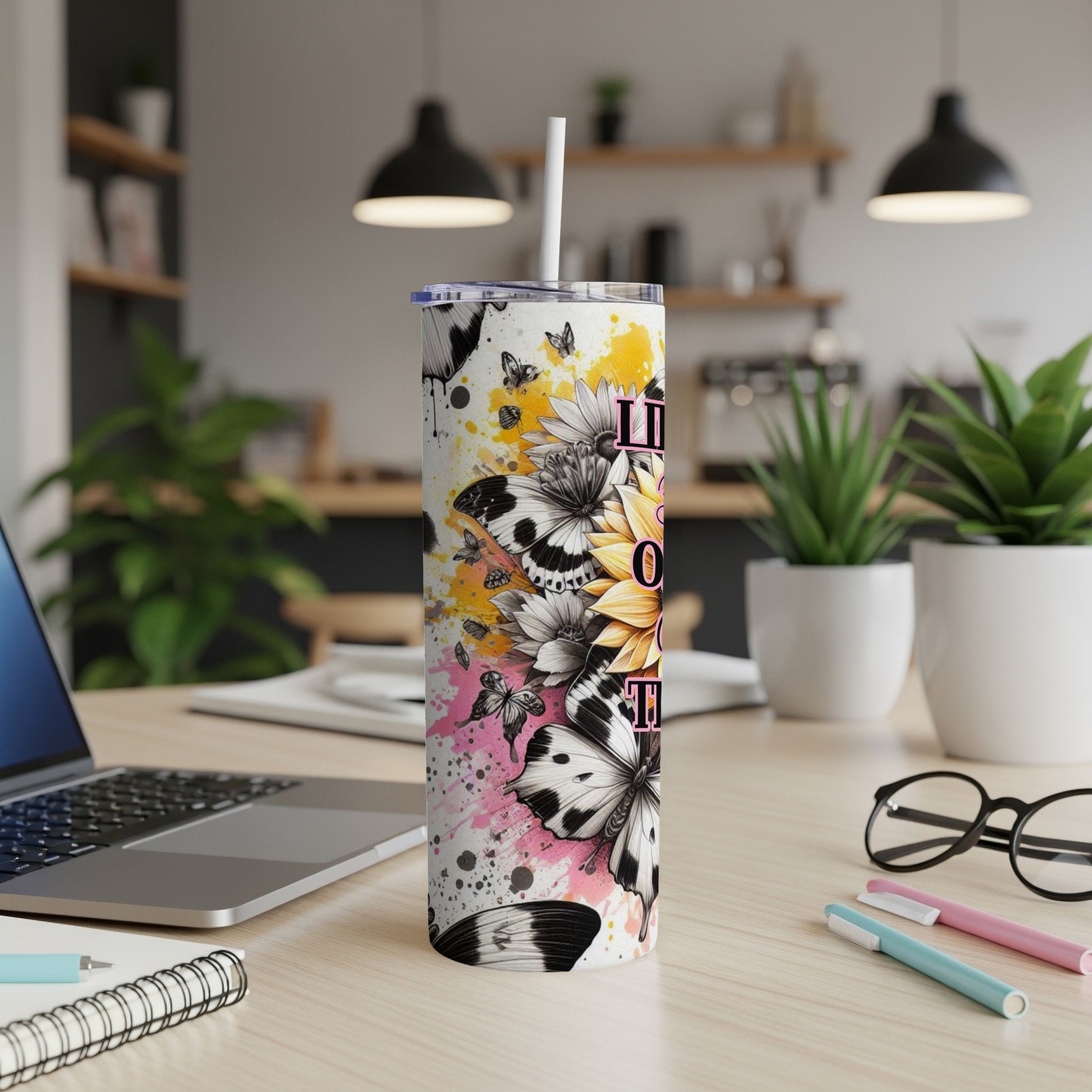 Tall tumbler with colorful butterfly and sunflower design.