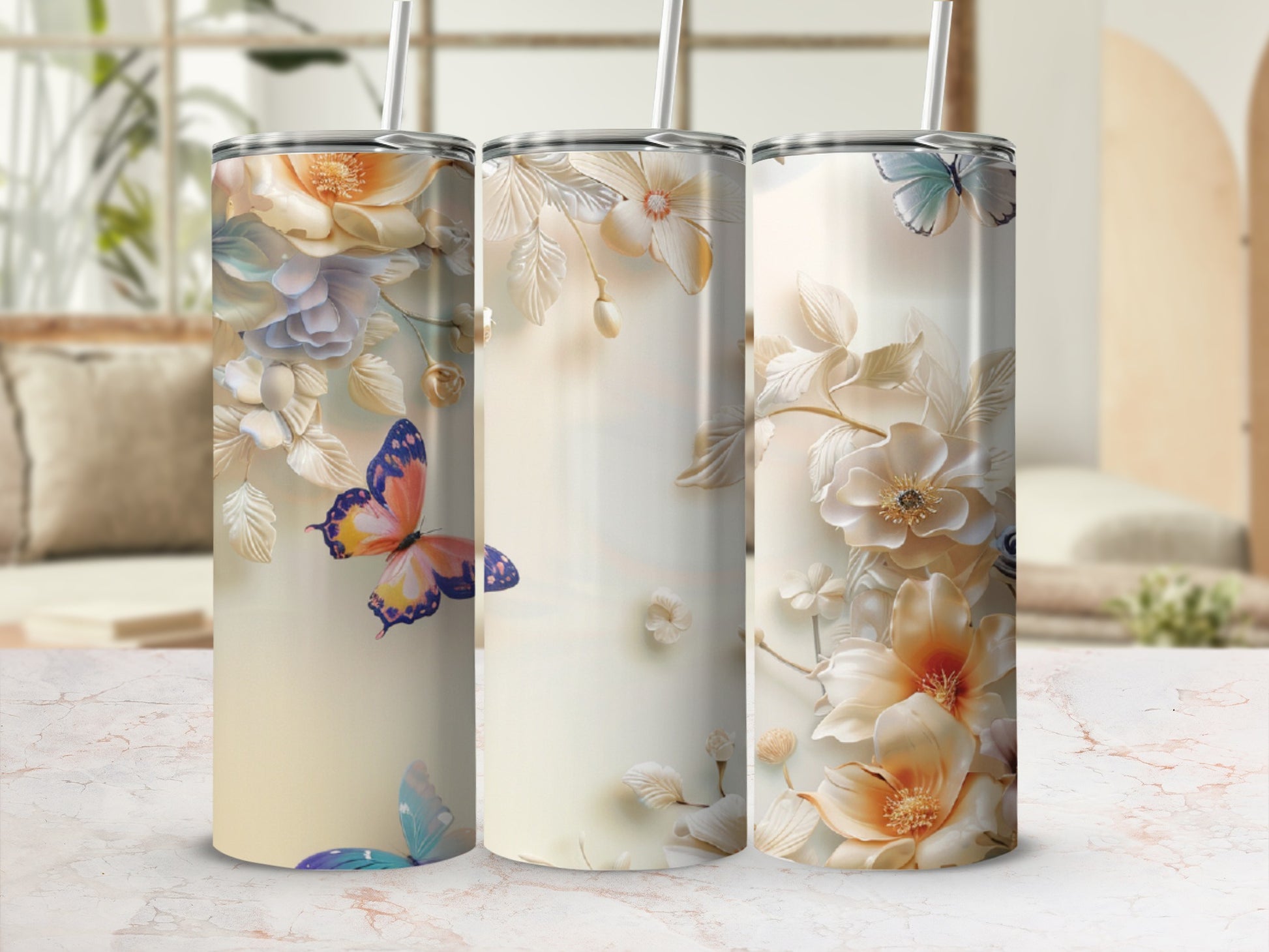 Three tall tumblers with pastel floral and butterfly designs.