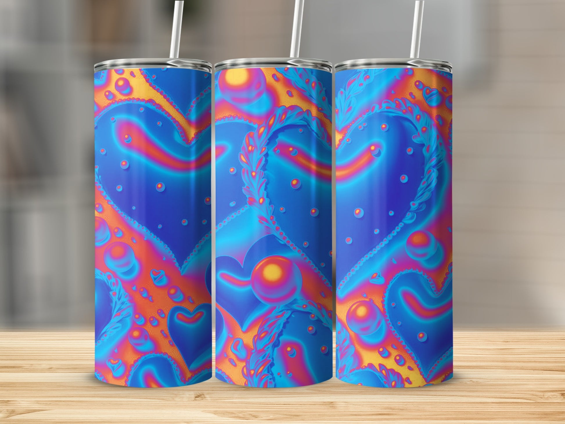 Three tumblers with psychedelic heart pattern and straw.