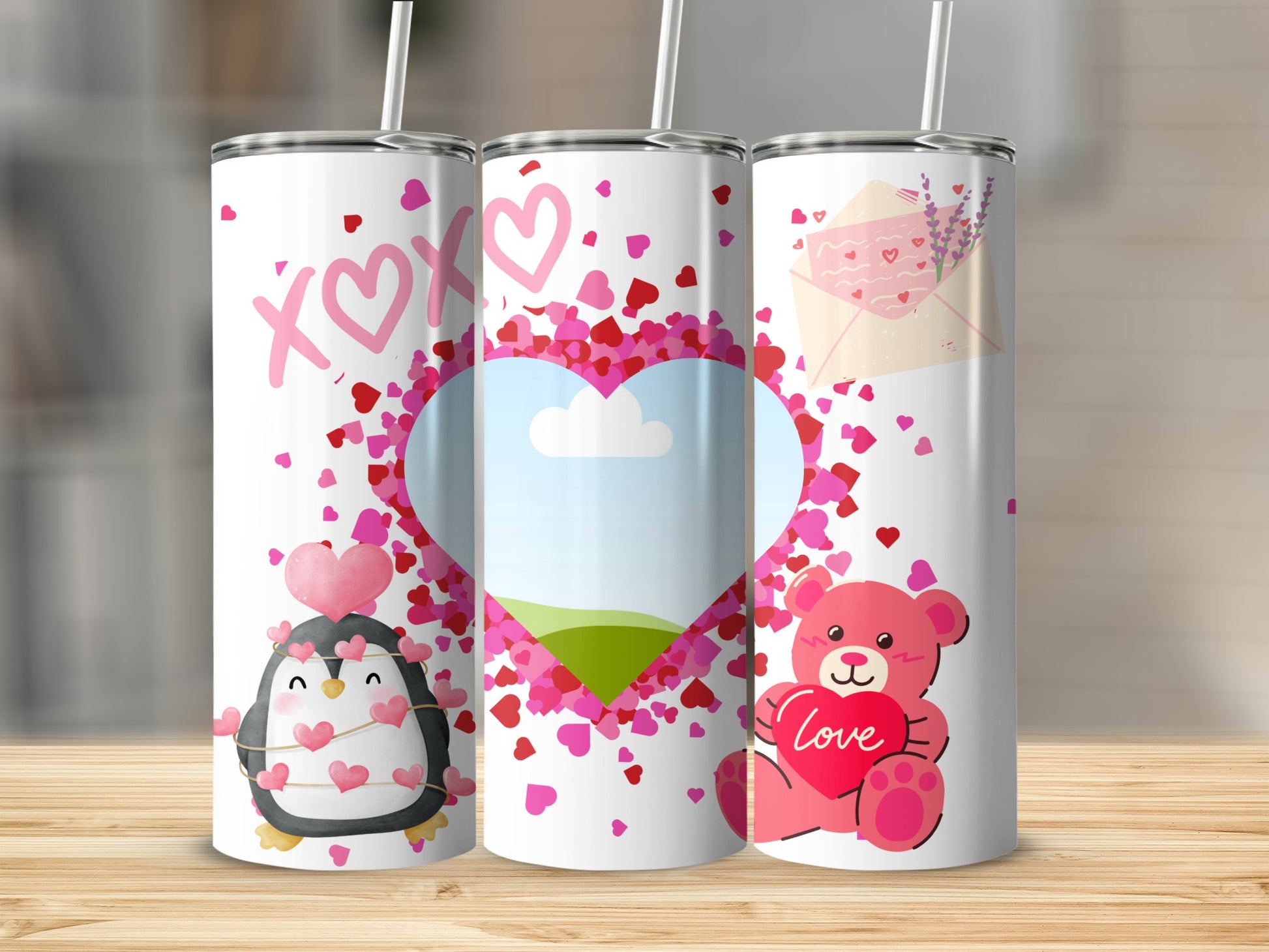 Three tumblers with Valentine's Day designs: penguin, heart, and teddy bear.