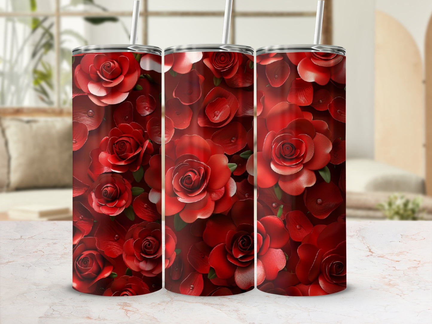 Three red rose print tumblers with straws, set against a blurred background.