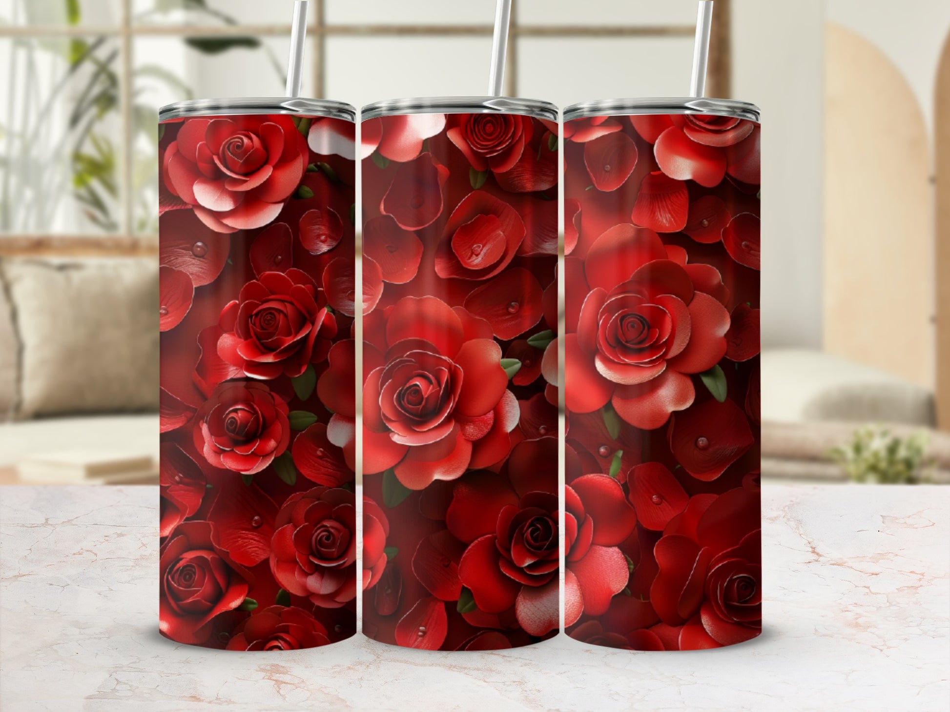 Three red rose print tumblers with straws, set against a blurred background.