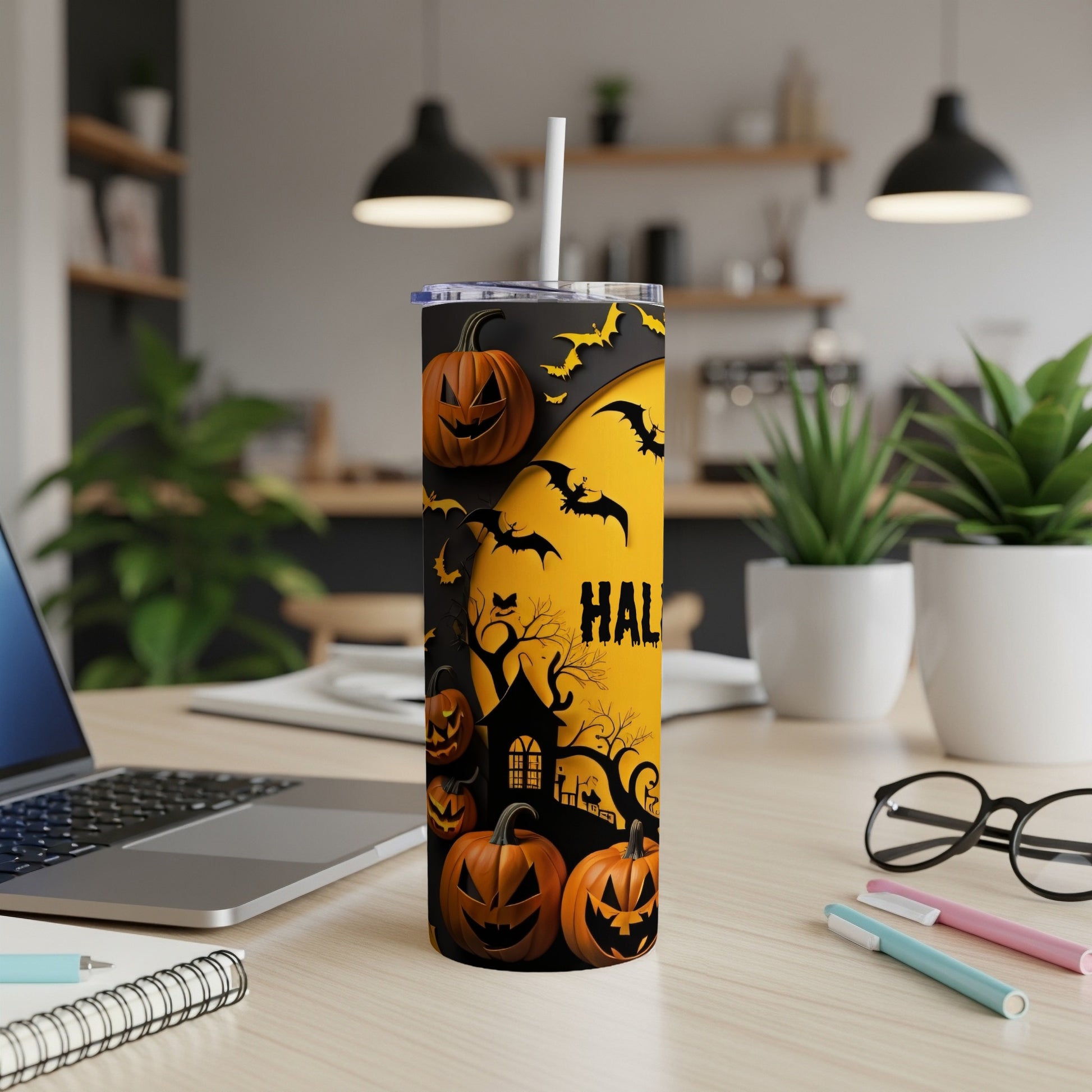 Halloween tumbler with pumpkins, bats, and haunted house graphic.