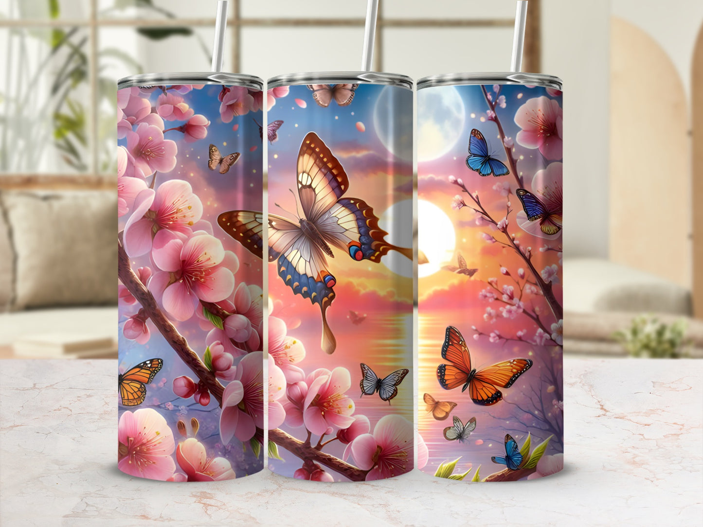 Pink cherry blossoms and butterflies on three tumblers against a soft, sunset background.