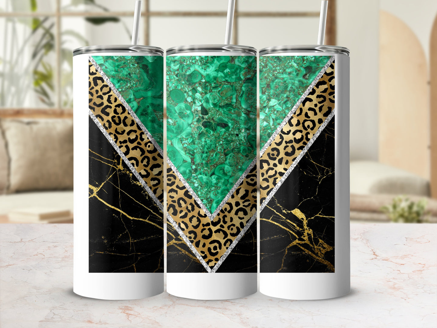 Three tumblers with malachite, leopard print, and black marble designs.