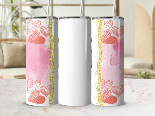 White tumbler with pink watercolor and heart design.