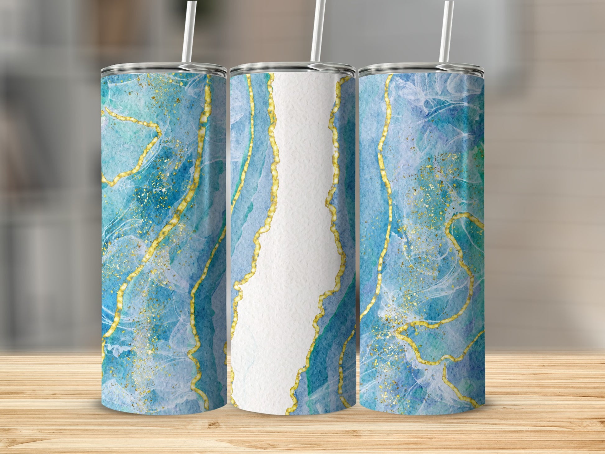 Three tumblers with blue and gold marbled design on a wooden surface.