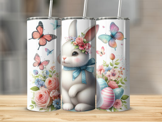 White bunny with flowers, butterflies, and Easter eggs on tumblers.