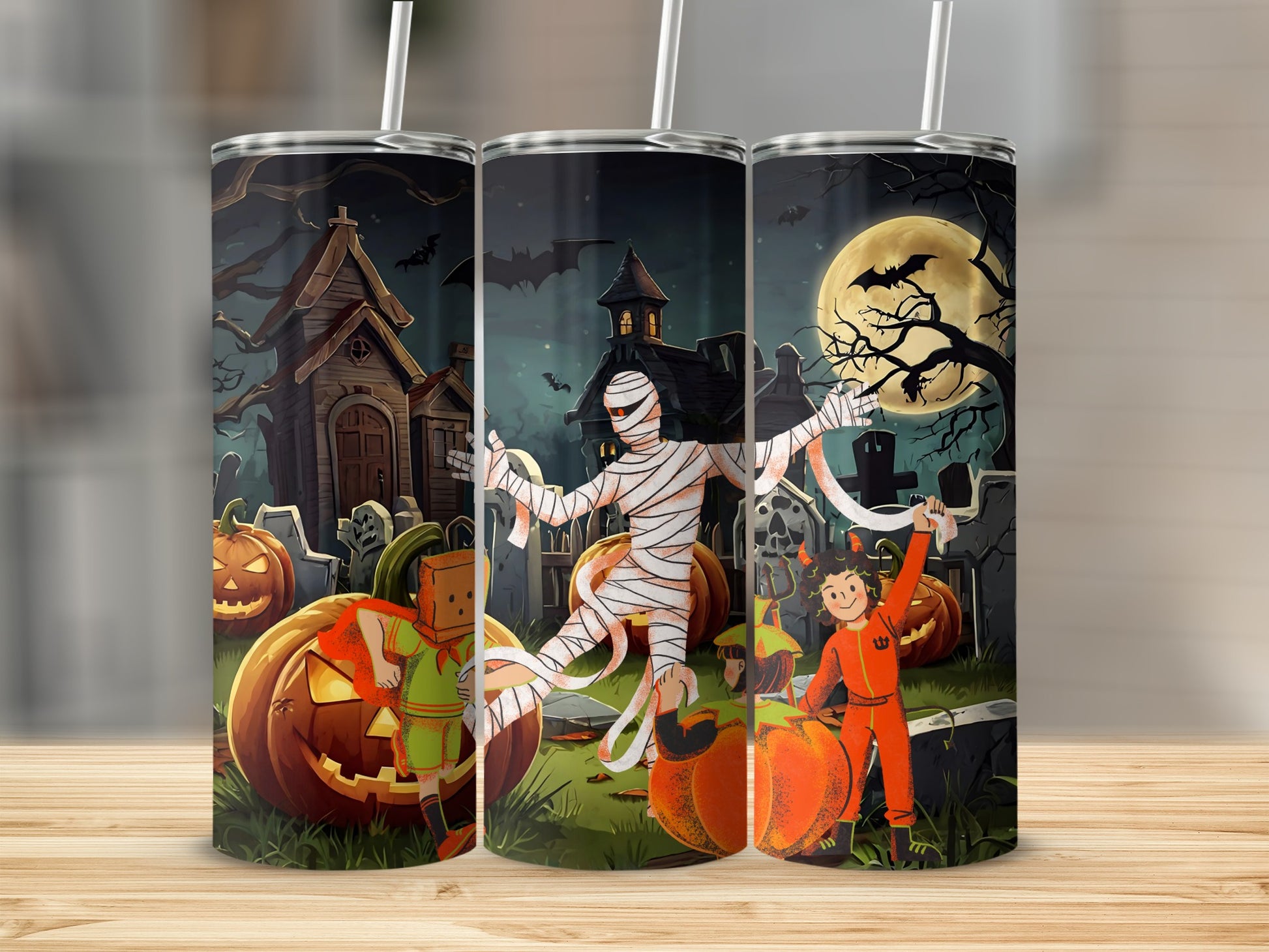 Halloween tumbler with pumpkins, mummy, and kids in costumes in a graveyard.