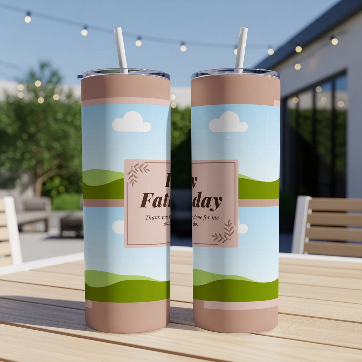 Two tumblers with "Happy Father's Day" design on a table outdoors.