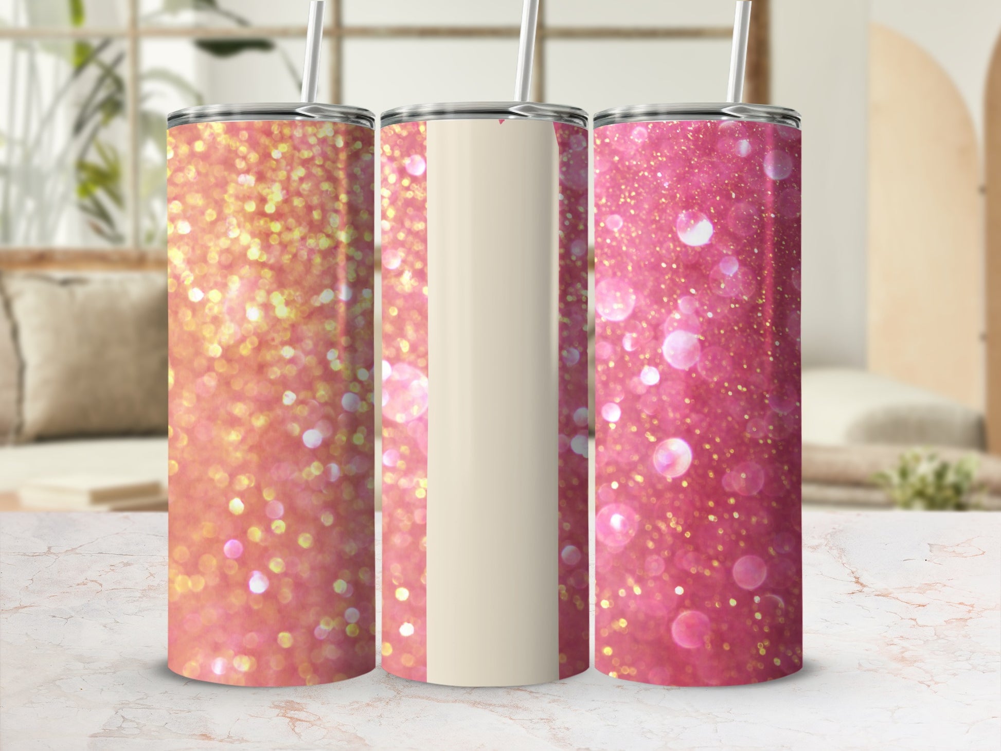 Three glitter tumblers with straw and a cream band.