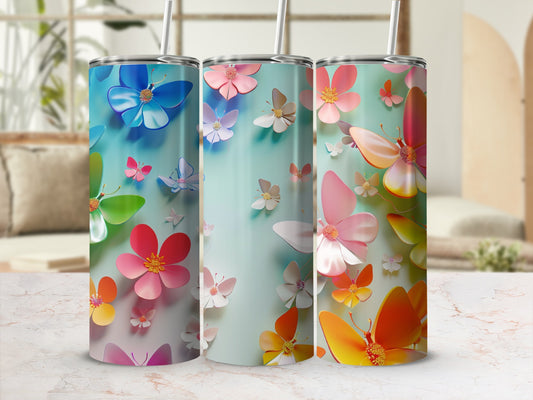 Three tumblers with colorful butterflies and flower designs.