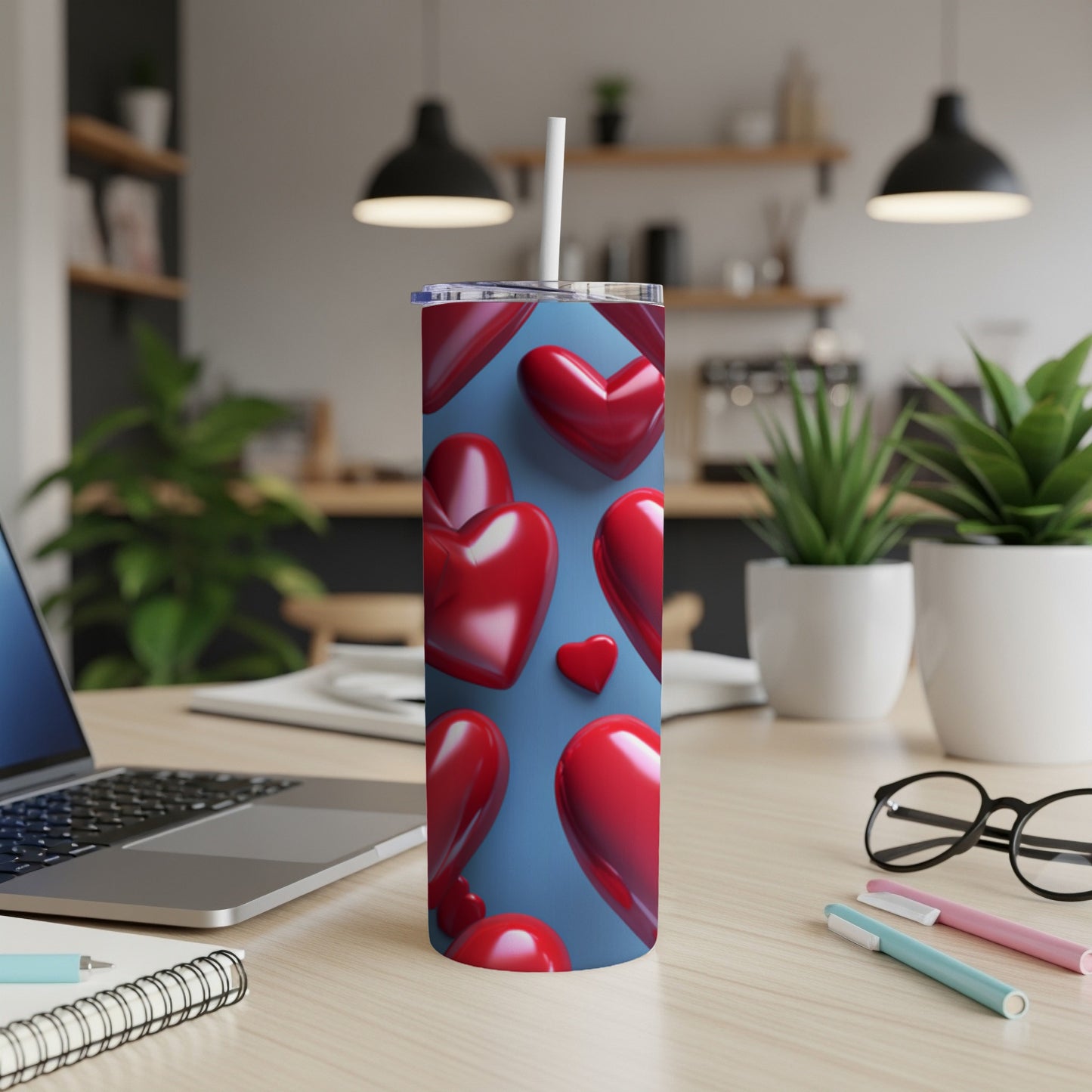 Red hearts pattern on a blue background wraps a tall, slender tumbler.
