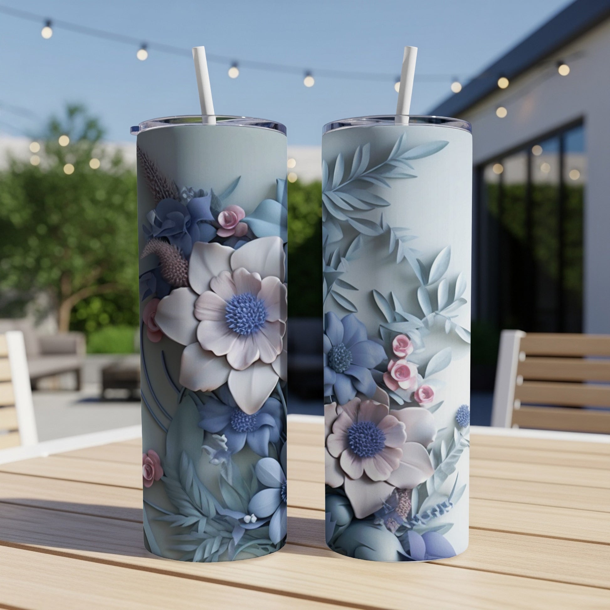 Two tall tumblers with pastel floral designs sit on a wooden table.