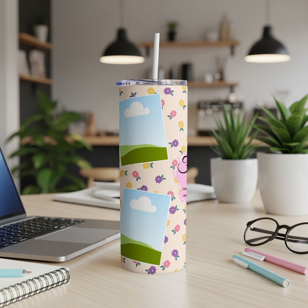 Tall tumbler with floral pattern, two photo frames, and a straw.
