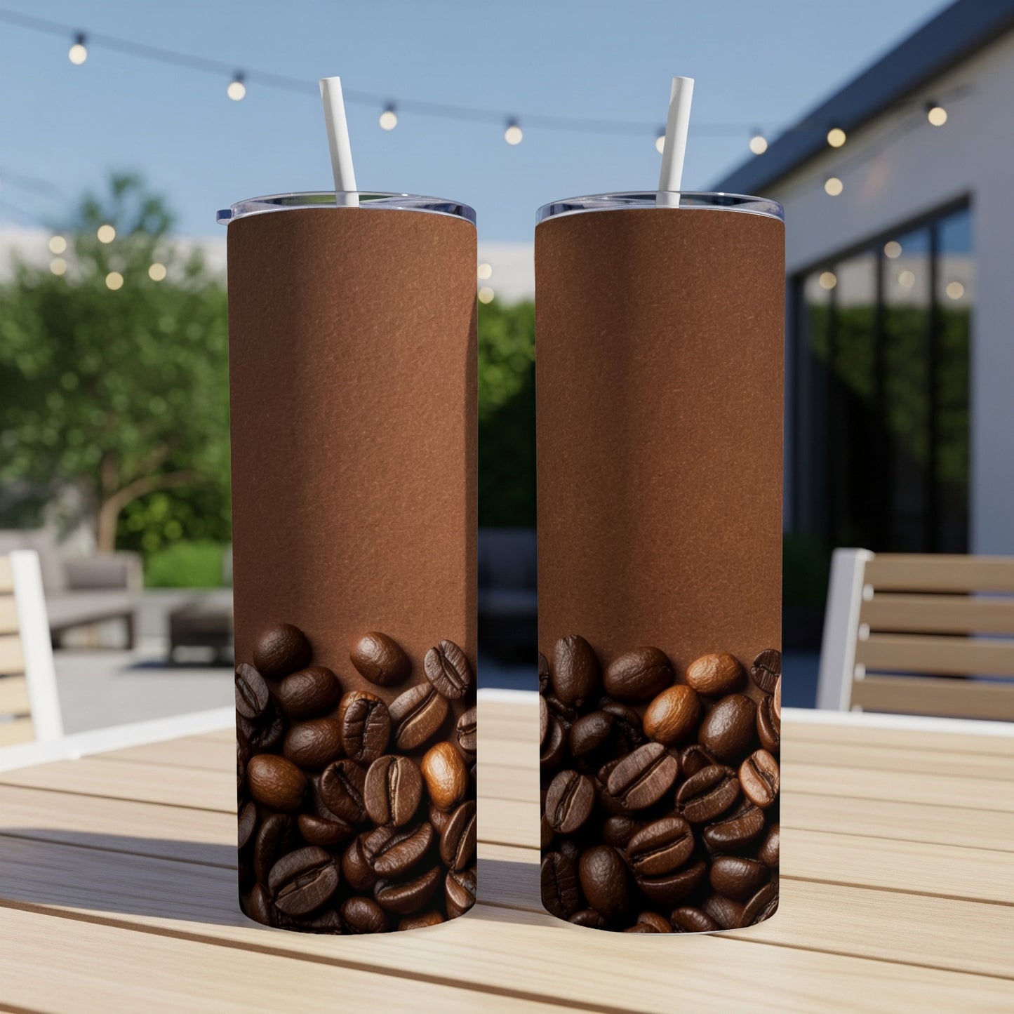 Two brown tumblers with coffee beans at the bottom, outdoors.
